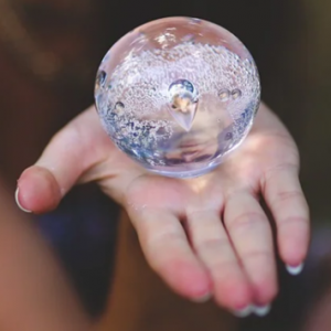 Hand holding a crystal ball